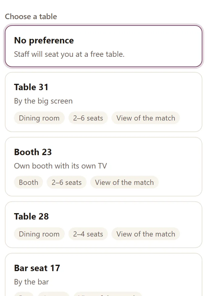 The guest's table choice in Goboblo's booking: the Choose a table list with No preference, Table 31 by the big screen, Booth 23 with its own TV, Table 28 and Bar seat 17 — with area, seats and view of the match per table, the demo venue's real view